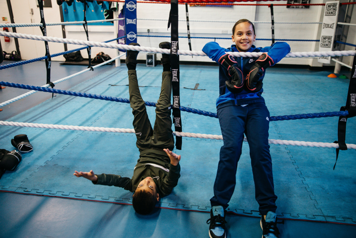 The photo shows young people having fun together in a boxing session